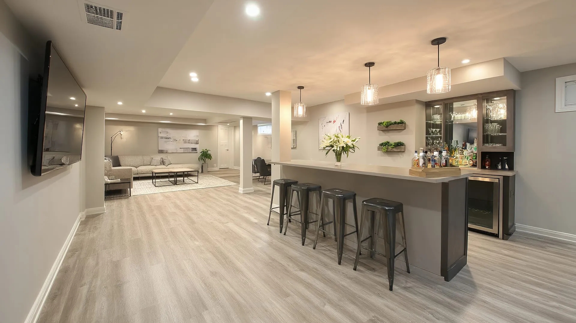 Finished basement with a custom wet bar by Timeless Builder Group