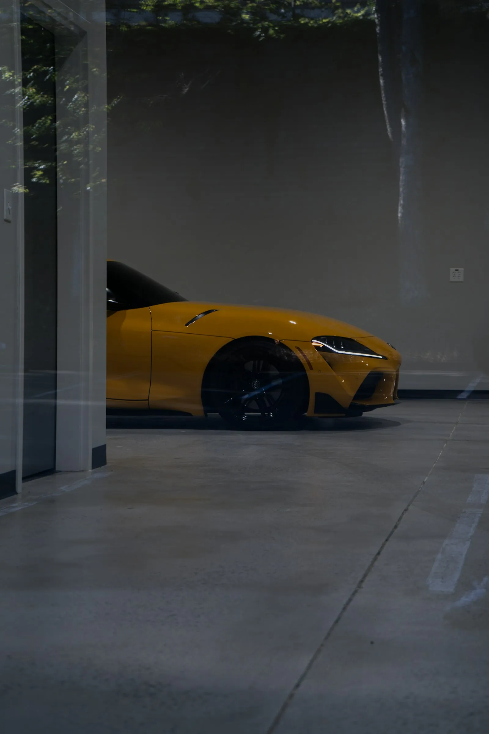A high-gloss coated garage floor with a sports car parked on it